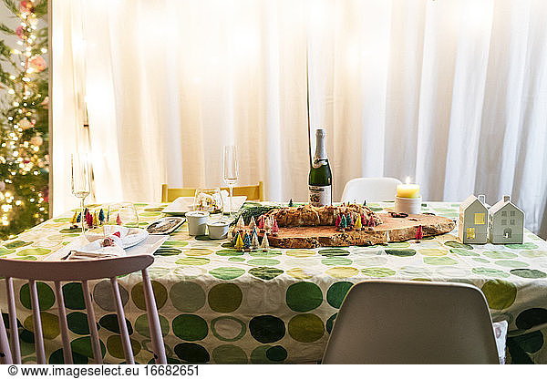 Decorated holidays dinner table at single home with green table circle cloth