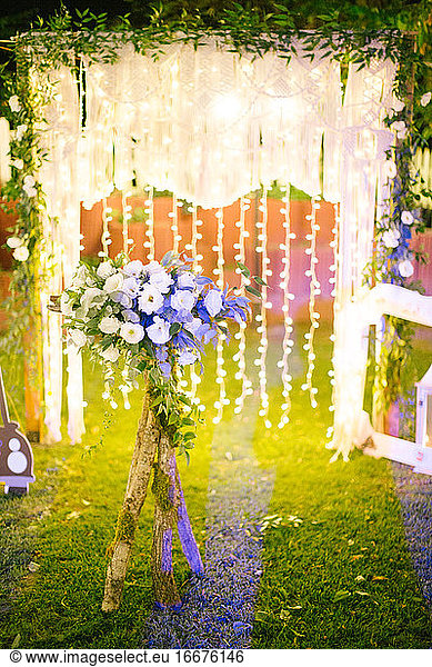 Decorated wedding arch. Wedding ceremony in the woods.