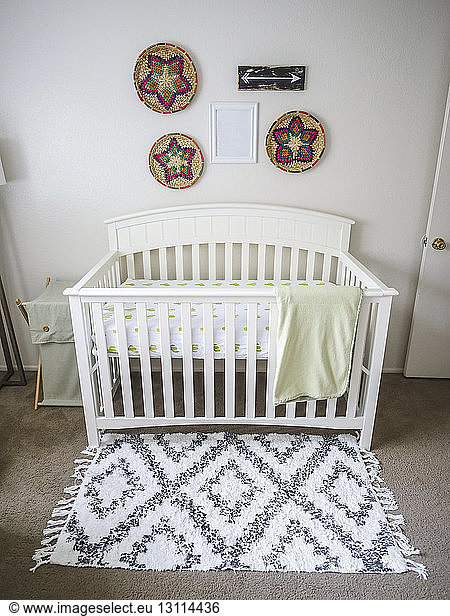 Decorations hanging on wall over crib in nursery