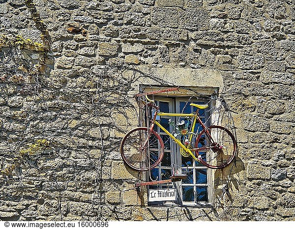 Decorative bicycle on a window of le Medieval Restaurant. Domme  Dordogne Department  Nouvelle Aquitaine  France.