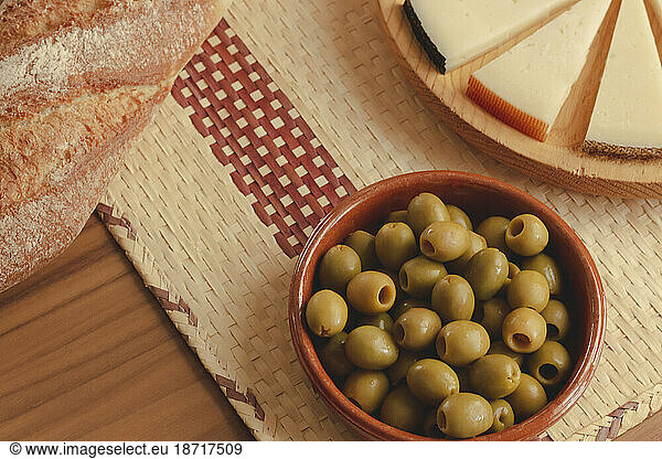 Delicious cheese board with rustic bread and olives.