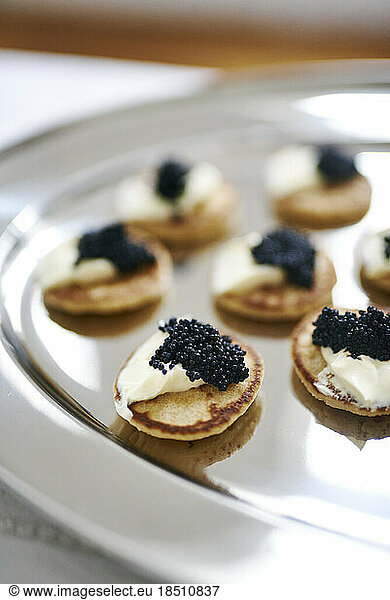 Delicious looking caviar and cream cheese platter on silver tray