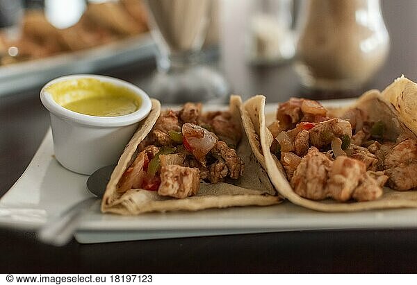 Delicious Mexican chicken tacos with salsa and pico de gallo served on the table  View of chicken tacos served on the table. Close-up of Mexican chicken tacos served