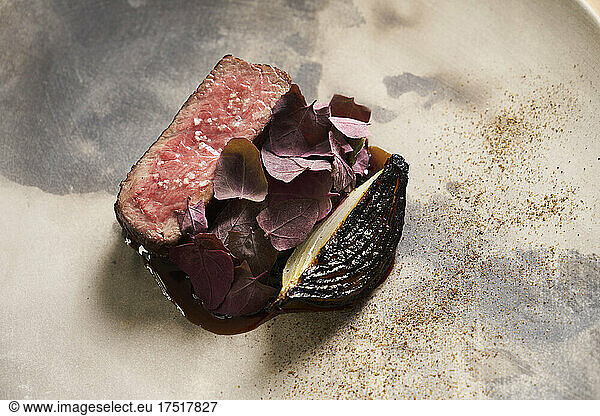 Delicious steak dish with modern plating on ceramic plate
