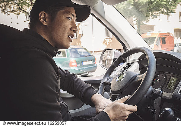 Delivery man driving truck