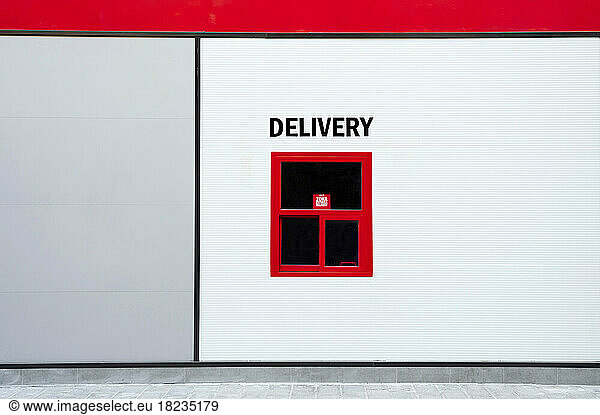 Delivery written above red window on wall