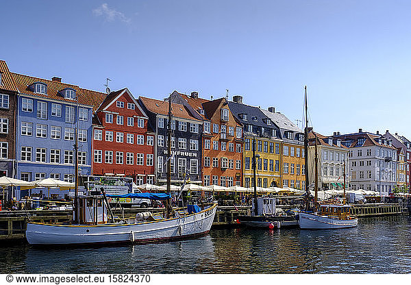 Denmark  Copenhagen  Boats moored along Nyhavn canal with colorful townhouses in background