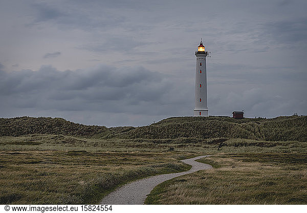 Denmark  Hvide Sande  Footpath toward coastal lighthouse at dusk
