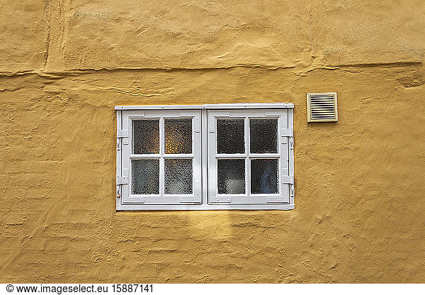 Denmark  Ribe  Small paned windows in yellow house wall