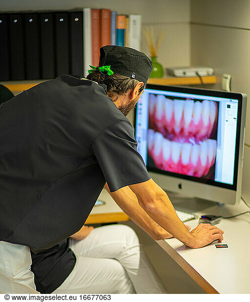 Dentist checking photos at Dental Clinic
