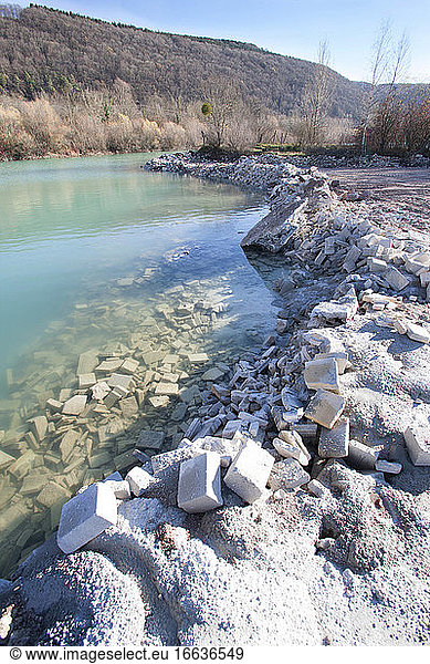 Deposit of industrial rubble at the edge of a gravel pit  Rejects of concrete blocks and concrete illegally accumulated and partially filling a gravel pit  Doubs  Franche-Comt?  France