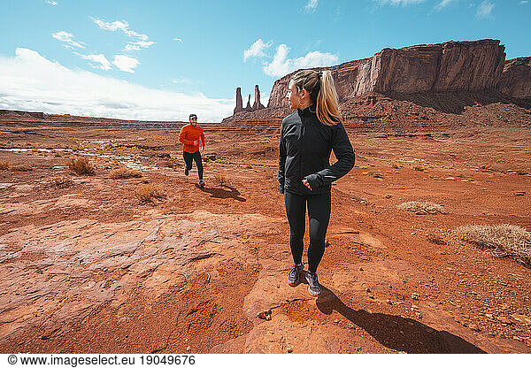 Desert Running Couple on Red Dirt