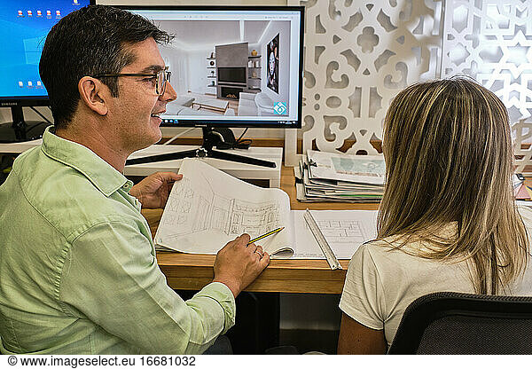 designer explains to his client the plans of his new work