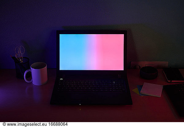 Desk illuminated with colored lights. Concept of new technologies