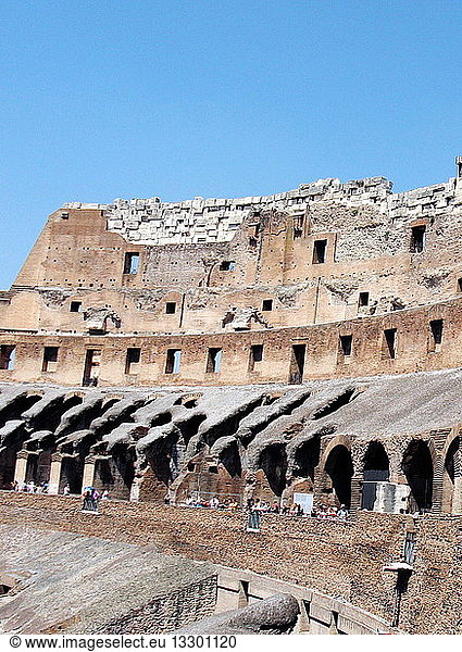 Detail from the Roman Collosseum (also known as the Flavian Amphitheatre)  an elliptical amphitheatre in the centre of Rome  Italy. Considered one of the greatest works of Roman architecture and engineering. Built from concrete and stone  with construction starting under the emperor Vespasian in 70 AD  finished in 80 AD under Titus. The amphitheatre also underwent modifications during the reign of Domitian. Named for its association with the Flavius family name of which these 3 emperors belonged. The Collosseum seated 50 000 spectators to view gladiatorial contests and performances. It was later repurposed for many other uses. One of the outstanding physical representations of Imperial Rome.