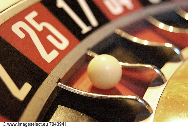 Detail of a roulette wheel with the ball on the number 25