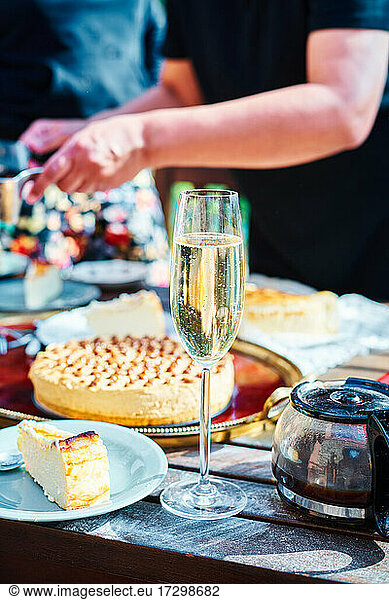 Detail of a table prepared to celebrate an outdoor party. Champagne  coffee  cake
