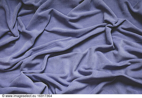 Detail of crumpled fleece blanket  focus in folds and creases