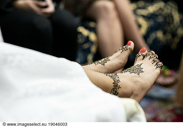 Detail of henna decoration on woman feet during a celebration.