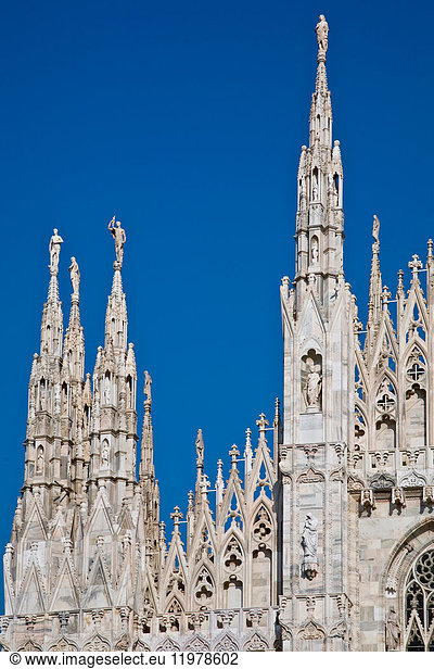 Detail of Milan Cathedral spires against blue sky  Milan  Italy
