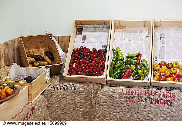 Detail of wooden crates with fresh vegetables in a farm shop.