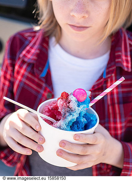 Detail shot of young person holding colorful shave ice