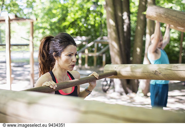 Determined woman exercising at outdoor gym