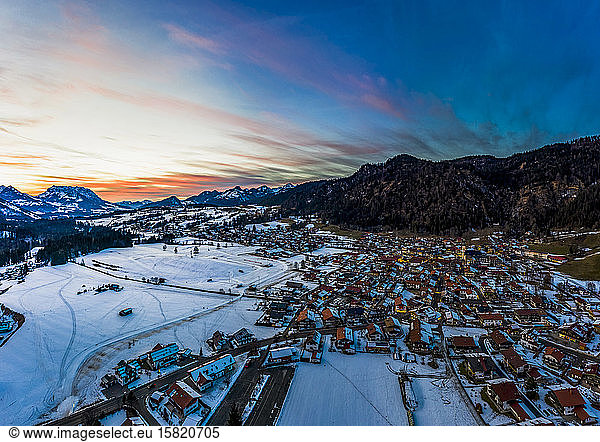 Deutschland  Bayern  Reit im Winkl  Helikopteransicht eines schneebedeckten Bergdorfes in der Morgendämmerung