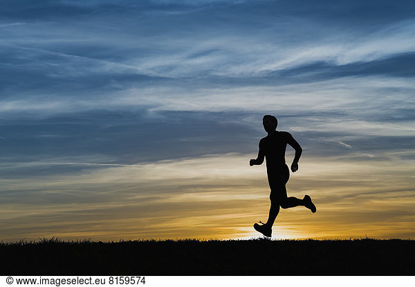 Deutschland Reife Männer joggen bei Sonnenuntergang