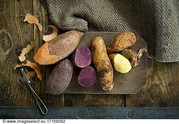 Different types of potatoes: sweet potato  Annabelle  purple sweet potato against rustic background