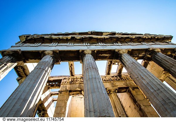 Different view of The Temple of Hephaestus. That temple is dedicated to the god of metal-working and craftsmanship  is located on Agoraios Kolonos  northwest of the Agora of Athens. We can see the bright sun shining through the columns of the temple