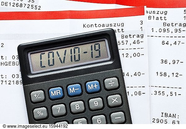 Digital Composing  Calculator with Covid-19 lettering and account statements  payments  symbolic photo for the effects of the Corona crisis on the economy  Germany  Europe