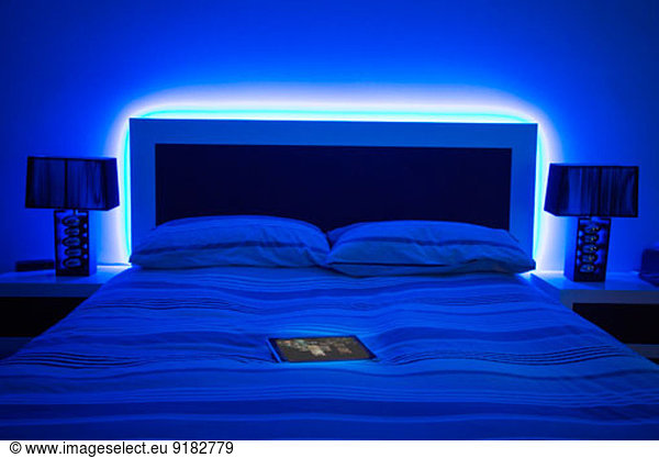 digital tablet on glowing bed