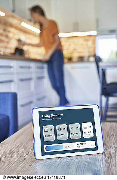 Digital tablet with smart home application on table at home