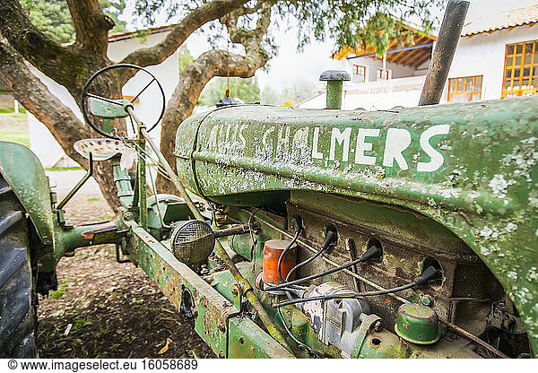 Dilapidated tractor sits in a yard in the mountains of Ecuador; Calicali  Ecuador