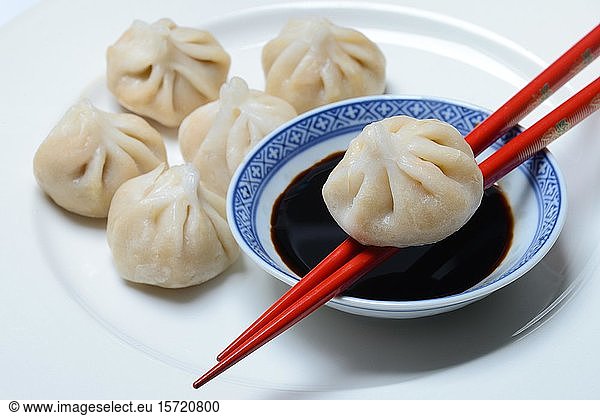 Dim Sum  filled dumplings and bowl with soy sauce  red chopsticks  Germany  Europe