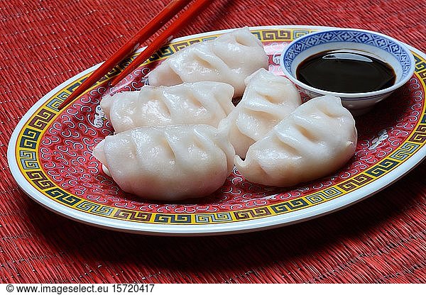 Dim Sum  filled dumplings on plate with chopsticks and soy sauce  Germany  Europe