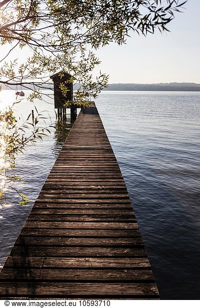 Diminishing perspective of boathouse and pier at lake  Schondorf  Ammersee  Bavaria  Germany