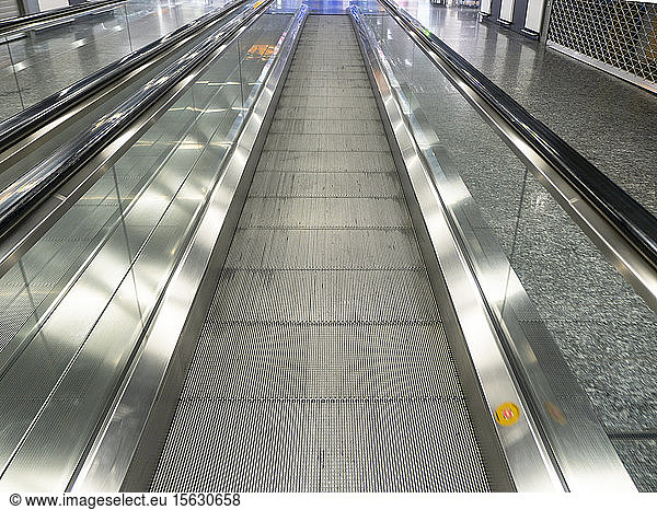 Diminishing perspective of empty moving walkway at airport