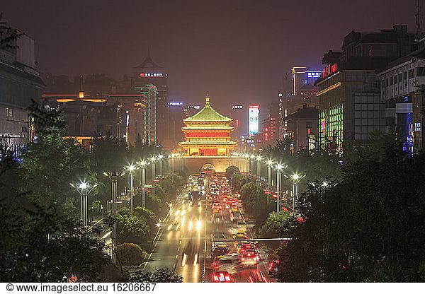 Diminishing perspective of road to Xian bell tower illuminated at night  China