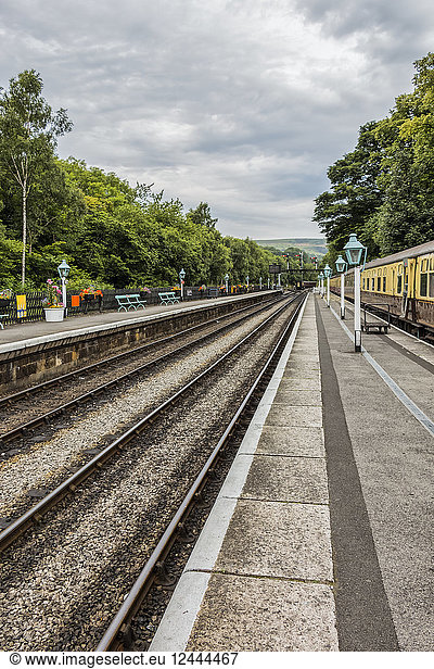 Diminishing perspective of the tracks and lamps at Goathland station  Yorkshire  England