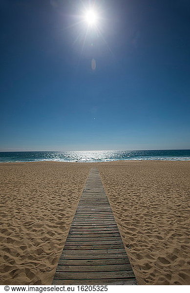Diminishing perspective of wooden boardwalk on beach  Comporta  Setubal  Portugal