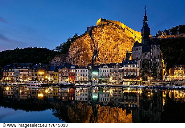 Dinant town  Collegiate Church of Notre Dame de Dinant over River Meuse and Pont Charles de Gaulle bridge and Dinant Citadel illuminated in the evening. Dinant  Belgium