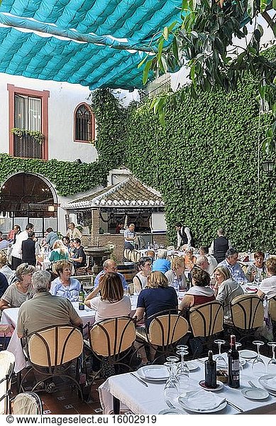 Diners waiting to eat in Casa Palacio Bandolero Restaurant  Cordoba  Cordoba Province  Andalusia  southern Spain. The historic centre of Cordoba is a UNESCO World Heritage Site.