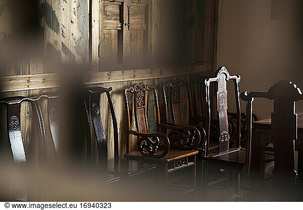 Dining chairs in wooden panelled room.