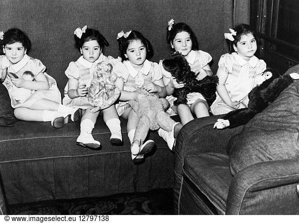 DIONNE QUINTUPLETS  1939. The Dionne quintuplets in a train car on a trip to Toronto  Ontario. Photograph  1939.
