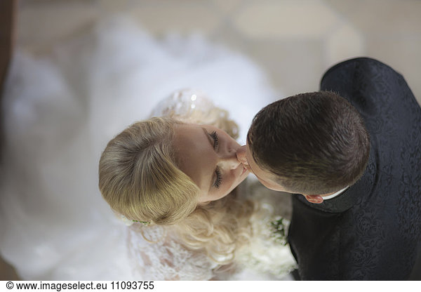 Directly above of a bride and groom kissing