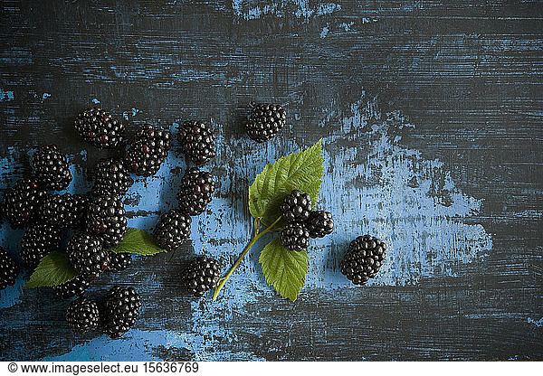 Directly above shot of blackberries with herbs on table