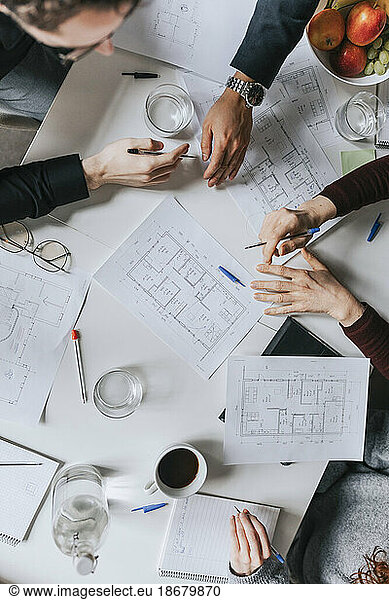 Directly above shot of business people working together at office
