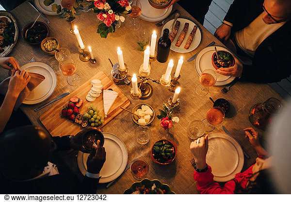 Directly above shot of friends enjoying food at dinner party